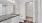a bathroom with a toilet, a mirror and a marble counter top