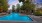 a pool with greenery in the background