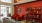 a clubhouse room with chairs and a red wall